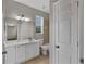 Bathroom offers a white vanity with a large mirror and natural light at 7732 Bulls Head Dr, Wesley Chapel, FL 33545