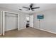 Cozy bedroom featuring neutral walls, ceiling fan, TV and closet with bi-fold doors at 7732 Bulls Head Dr, Wesley Chapel, FL 33545