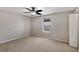 Neutral bedroom featuring a ceiling fan and plush carpet for a cozy and relaxing atmosphere at 7732 Bulls Head Dr, Wesley Chapel, FL 33545