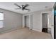 Bright bedroom featuring carpeted floors and a closet with bi-fold doors at 7732 Bulls Head Dr, Wesley Chapel, FL 33545