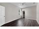 Bedroom features neutral walls, gray wood-look floors, and a walk-in closet at 7732 Bulls Head Dr, Wesley Chapel, FL 33545