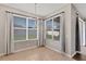 Bright dining area with tile flooring, large windows, and neutral paint at 7732 Bulls Head Dr, Wesley Chapel, FL 33545