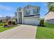 Inviting two-story home showcasing a manicured lawn and a spacious two-car garage at 7732 Bulls Head Dr, Wesley Chapel, FL 33545