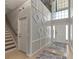 Open foyer with a staircase, high ceiling, decorative wall trim, and tile flooring at 7732 Bulls Head Dr, Wesley Chapel, FL 33545