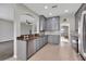 Spacious kitchen featuring modern appliances, granite countertops, and gray cabinetry at 7732 Bulls Head Dr, Wesley Chapel, FL 33545