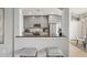 Modern kitchen featuring stainless steel appliances, a breakfast bar, and ample cabinet space at 7732 Bulls Head Dr, Wesley Chapel, FL 33545