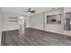 Large living room boasts stylish floors, arched entries, and flows into a modern kitchen at 7732 Bulls Head Dr, Wesley Chapel, FL 33545
