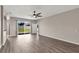Spacious living room offers stylish floors and sliding glass doors to the fenced backyard at 7732 Bulls Head Dr, Wesley Chapel, FL 33545