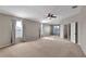 Large main bedroom with ample natural light, neutral carpet, and ensuite bathroom at 7732 Bulls Head Dr, Wesley Chapel, FL 33545