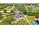Aerial view showcasing a property with a pool, backyard, and fenced perimeter at 7818 Holiday Dr, Spring Hill, FL 34606