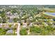 Aerial view of a residential neighborhood with lush trees and a home with fenced yard at 7818 Holiday Dr, Spring Hill, FL 34606