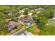 An aerial view displays a property with a pool, backyard, and fenced perimeter at 7818 Holiday Dr, Spring Hill, FL 34606