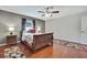 Cozy bedroom featuring hardwood floors, two end tables and a decorative rug at 7818 Holiday Dr, Spring Hill, FL 34606