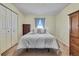 Bedroom features bright lighting, carpet floors, and a wardrobe closet at 7818 Holiday Dr, Spring Hill, FL 34606