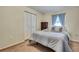 Bedroom features bright lighting, carpet floors, and a wardrobe closet at 7818 Holiday Dr, Spring Hill, FL 34606