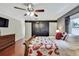 Bedroom with wood floors, dresser, large wardrobe, and barn style closet doors at 7818 Holiday Dr, Spring Hill, FL 34606