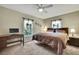 Bedroom features carpet floors, a fan, natural lighting, and a work station at 7818 Holiday Dr, Spring Hill, FL 34606