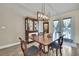 Dining room featuring hardwood floors, a table with chairs, and built in cabinets at 7818 Holiday Dr, Spring Hill, FL 34606