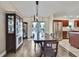 Dining room featuring hardwood floors, a table with chairs, and built in cabinets at 7818 Holiday Dr, Spring Hill, FL 34606