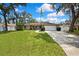 Inviting home exterior with a manicured lawn and walkway leading to the front entrance at 7818 Holiday Dr, Spring Hill, FL 34606