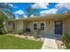Close up of home front with stone facade and blue front door at 7818 Holiday Dr, Spring Hill, FL 34606