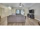 Cozy living room featuring a ceiling fan, laminate flooring, and a comfortable gray sofa at 7818 Holiday Dr, Spring Hill, FL 34606