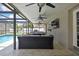 Spacious covered patio with ceiling fans, a TV, and outdoor seating for comfortable entertaining at 7818 Holiday Dr, Spring Hill, FL 34606