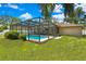 Enjoy the screened-in pool with an outdoor kitchen, perfect for entertaining at 7818 Holiday Dr, Spring Hill, FL 34606
