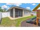 This lovely backyard has a play set, neutral-colored exterior and a white fence at 7822 Atwood Dr, Wesley Chapel, FL 33545