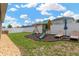 The backyard has a playset and lounge chairs on a green lawn at 7822 Atwood Dr, Wesley Chapel, FL 33545