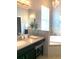 A bathroom features a vanity, bathtub, sconces, and a chandelier at 7822 Atwood Dr, Wesley Chapel, FL 33545