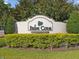 Palm Cove deed-restricted community sign surrounded by lush green landscaping at 7822 Atwood Dr, Wesley Chapel, FL 33545