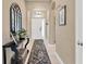 Inviting entryway showcasing stylish decor, a console table, and a decorative rug that leads into the home at 7822 Atwood Dr, Wesley Chapel, FL 33545