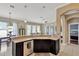 Open kitchen with stainless steel dishwasher, dark cabinets, and tan countertop at 7822 Atwood Dr, Wesley Chapel, FL 33545