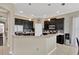 Well-lit kitchen featuring dark cabinets, stainless steel appliances, and a mosaic tile backsplash at 7822 Atwood Dr, Wesley Chapel, FL 33545