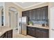 Kitchen with stainless steel refrigerator, dark wood cabinets, and mosaic backsplash at 7822 Atwood Dr, Wesley Chapel, FL 33545