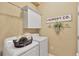 Functional laundry room equipped with a washer, dryer, and ample storage space, perfect for organization at 7822 Atwood Dr, Wesley Chapel, FL 33545