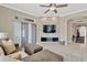 Comfortable living room with stone accent wall and large windows with bright, natural light at 7822 Atwood Dr, Wesley Chapel, FL 33545
