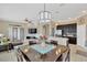 Open floor plan featuring a kitchen, dining area, and living room with stone accent wall at 7822 Atwood Dr, Wesley Chapel, FL 33545