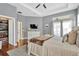 A comfortable main bedroom with a TV, dresser, walk-in closet, and ceiling fan at 7822 Atwood Dr, Wesley Chapel, FL 33545