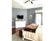 A comfortable main bedroom with a TV, dresser, guitar, rug, and ceiling fan at 7822 Atwood Dr, Wesley Chapel, FL 33545