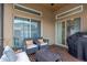 The covered patio includes comfortable seating and a BBQ grill at 7822 Atwood Dr, Wesley Chapel, FL 33545