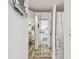 Hallway view of the bathroom, kitchen, and mirrored closet at 880 Mandalay Ave # N607, Clearwater Beach, FL 33767