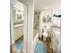Bright bathroom features dual vanities, wood-look floors, tub/shower combo, and charming nautical decor at 880 Mandalay Ave # N607, Clearwater Beach, FL 33767