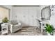 Bright bedroom featuring a cozy armchair, built-in wardrobe, and stylish decor at 880 Mandalay Ave # N607, Clearwater Beach, FL 33767