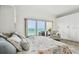 Bright bedroom with a large bed and sliding glass doors leading to a balcony with ocean view at 880 Mandalay Ave # N607, Clearwater Beach, FL 33767