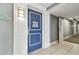 Condo front door with white trim and blue door with beach-themed decor in hallway at 880 Mandalay Ave # N607, Clearwater Beach, FL 33767