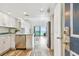 Bright kitchen with white cabinets, stainless steel appliances and views of the ocean at 880 Mandalay Ave # N607, Clearwater Beach, FL 33767