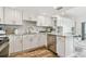 Bright kitchen with stainless appliances, white cabinets, and view into the living area at 880 Mandalay Ave # N607, Clearwater Beach, FL 33767