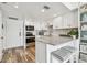 Modern kitchen with stainless steel appliances, breakfast bar, and white cabinetry at 880 Mandalay Ave # N607, Clearwater Beach, FL 33767